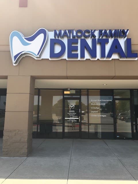 Storefront of Matlock Family Dental at Matlock Oaks Crossing, with the practice's blue tooth logo on the sign above the entrance